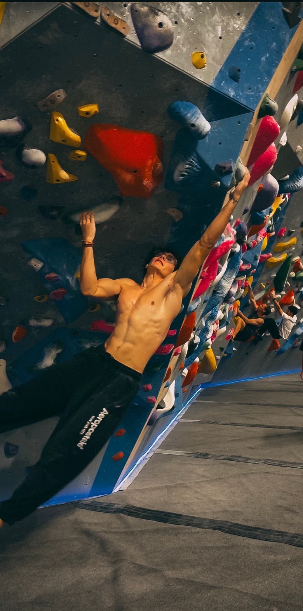 Matias mid-dyno on a steep indoor wall