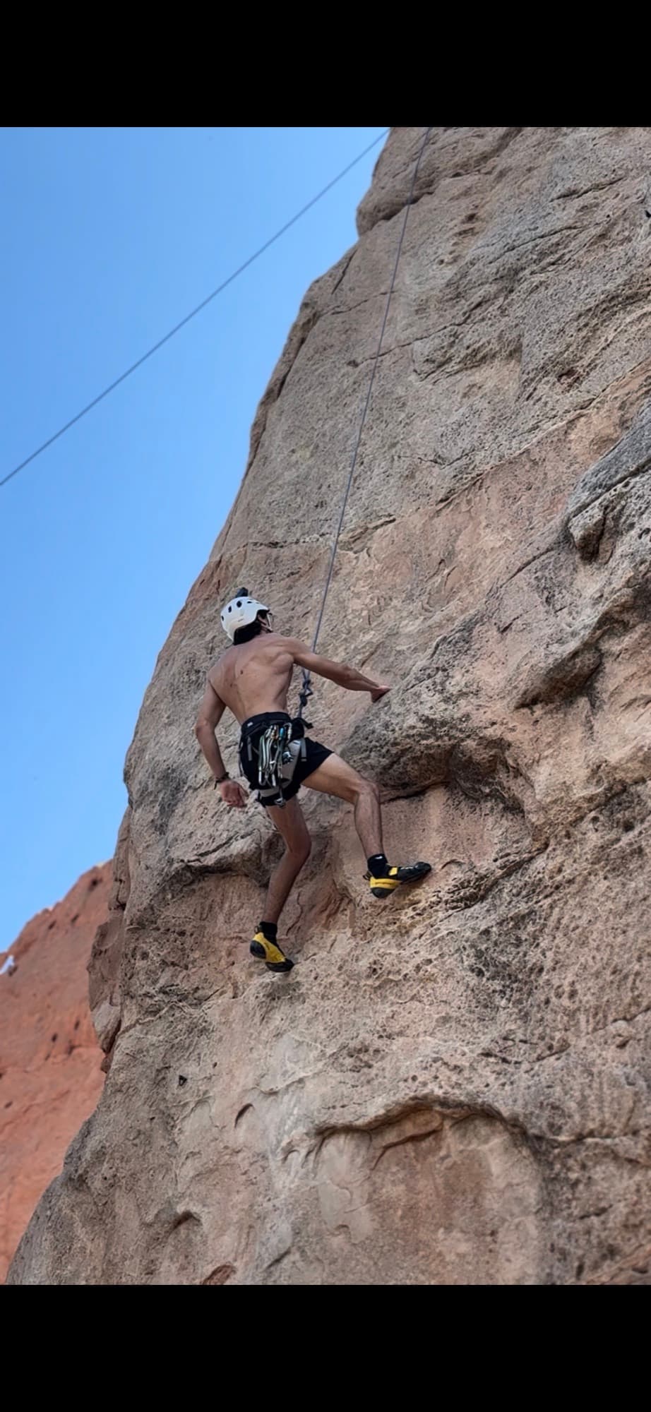 On real rock, helmet and harness